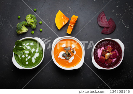 Three bowls with colourful vegetable soups black background healthy diet cooking detox 134208146