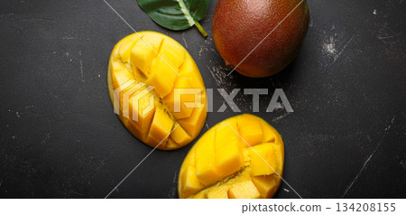 Ripe tropical sliced whole mangoes leaves dark background healthy exotic fruit 134208155