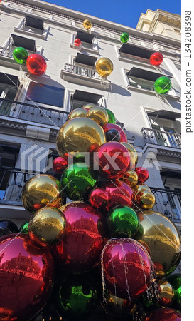 Festive christmas and new year ornament display on city building for holiday celebration Festive christmas and new year ornament display on city building for holiday celebration 134208398