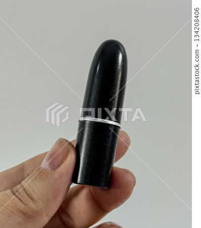 Black Lipstick Tube in Hand 134208406
