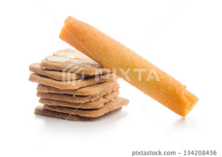 Sweet wafer rolls and gingerbread isolated on white background. Sweet wafer rolls and gingerbread isolated on white background. 134208436