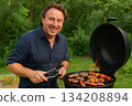 Man Grilling Outdoors 134208894