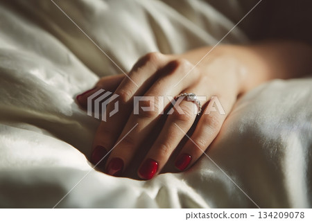 Delicate Woman Hand on Luxurious Silk Surface Delicate Woman Hand on Luxurious Silk Surface 134209078