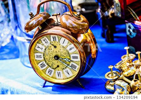 Antique gold alarm clock on display. Vintage, retro Antique gold alarm clock on display. Vintage, retro 134209194