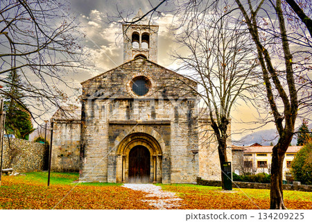 Exterior of the Monastery of Sant Pere de Camprodon in November with autumn leaves 134209225