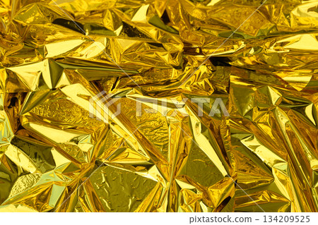 high-resolution close-up shot of crumpled golden foil 134209525