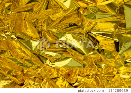 high-resolution close-up shot of crumpled golden foil.Selective focus. 134209689