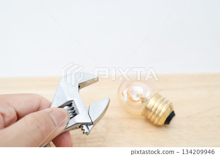 A simple image of electrical work and replacement work shown with light bulbs and tools. 134209946