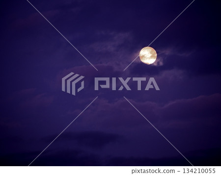 A full moon obscured by purple clouds 134210055