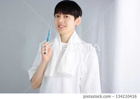 Oral care: A young man holding a toothbrush 134210416