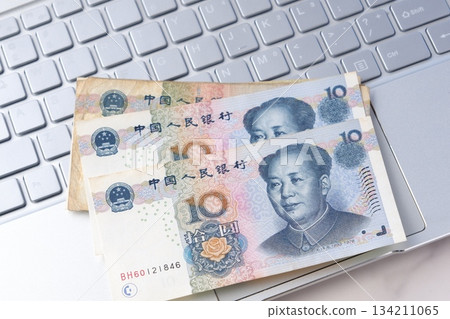中國貨幣、人民幣紙幣和帶有毛澤東肖像的筆記型電腦 134211065