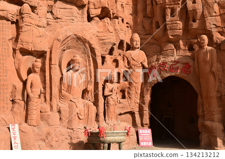 Buddha statue sculpture on the cliff face of the temple in front of the entrance gate at the Tianshan Grand Canyon, or Kesileya Grand Canyon, is a stunning natural feature in Xinjiang, China, Buddha statue sculpture on the cliff face of the temple in front of the entrance gate at the Tianshan Grand Canyon, or Kesileya Grand Canyon, is a stunning natural feature in Xinjiang, China, 134213212