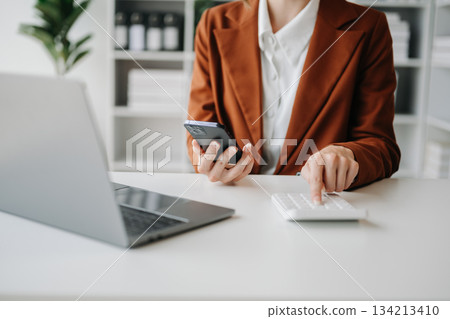 businesswoman or accountant hand typing laptop working to calculate businesswoman or accountant hand typing laptop working to calculate 134213410