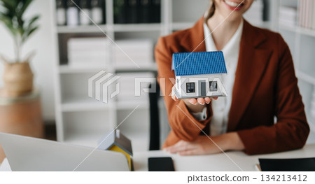 Considering buying a home, investing in real estate. Broker signs a sales agreement. Considering buying a home, investing in real estate. Broker signs a sales agreement. 134213412