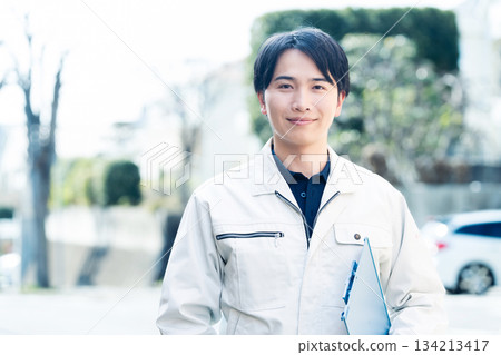 A man wearing work clothes A man wearing work clothes 134213417