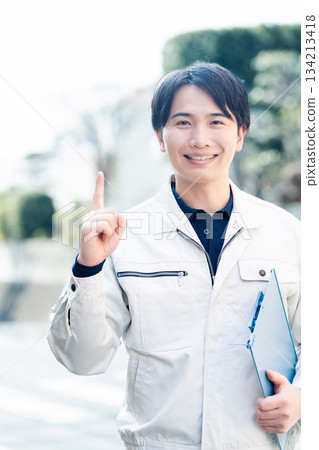 A man wearing work clothes A man wearing work clothes 134213418