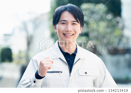 A man wearing work clothes A man wearing work clothes 134213419