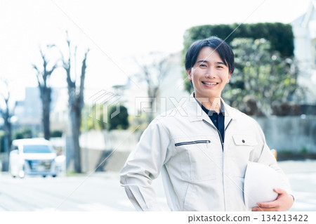 A man wearing work clothes A man wearing work clothes 134213422