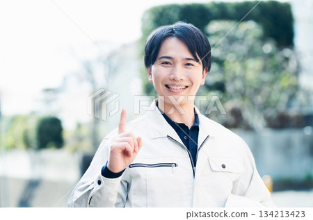 A man wearing work clothes 134213423