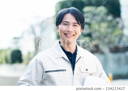A man wearing work clothes A man wearing work clothes 134213427