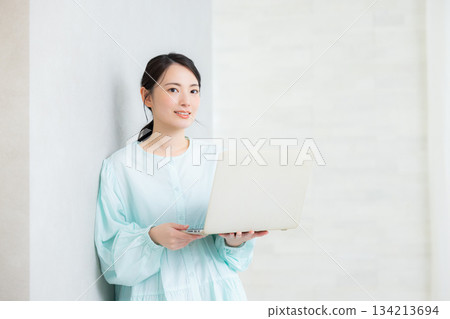 A woman using a computer 134213694