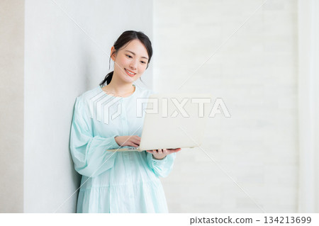 A woman using a computer A woman using a computer 134213699