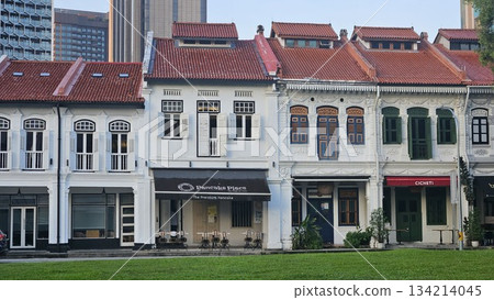 A row of ornate shophouses with red-tiled roofs A row of ornate shophouses with red-tiled roofs 134214045