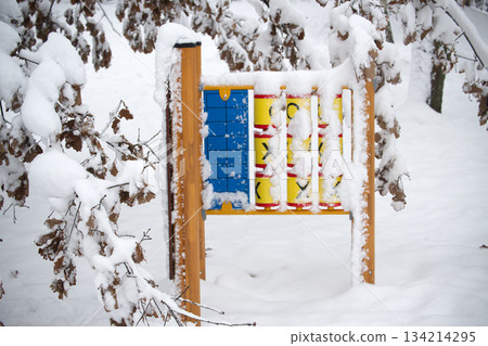Winter playground covered in snow with a tic-tac-toe game 134214295