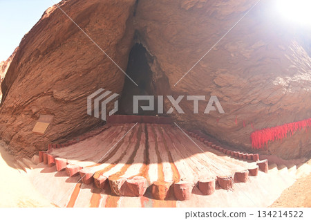Water flow channel at the entrance to A-ai Cave at The Tianshan Grand Canyon, or Kesileya Grand Canyon, is a stunning natural feature in Xinjiang, China, characterized by its distinctive red canyons, Water flow channel at the entrance to A-ai Cave at The Tianshan Grand Canyon, or Kesileya Grand Canyon, is a stunning natural feature in Xinjiang, China, characterized by its distinctive red canyons, 134214522