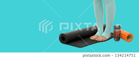 Yoga session setup features mat and water bottle on bright floor Yoga session setup features mat and water bottle on bright floor 134214751
