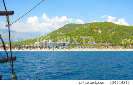 Beach resort by mountains on turquoise sea view from water horizontal 134214811