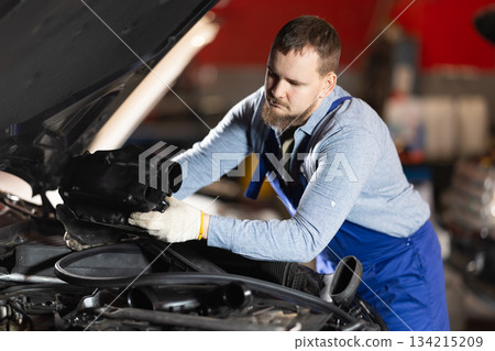 man checks the condition of the engine and oil under the hood 134215209
