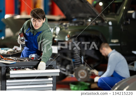 Mechanic with tools in a car service Mechanic with tools in a car service 134215220