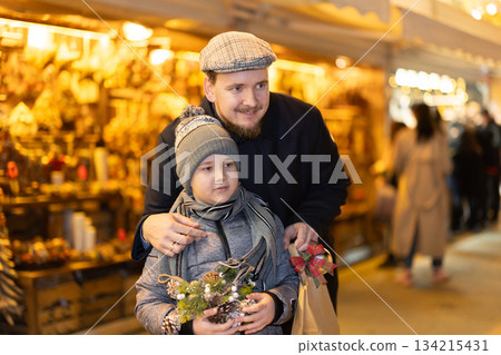 Dad and son at the fair in winter Dad and son at the fair in winter 134215431