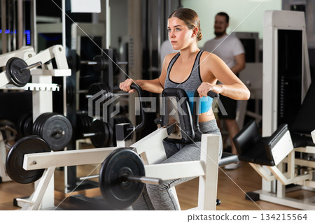 Woman exercising her back Woman exercising her back 134215564