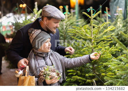 Man and his son choose a Christmas tree 134215682