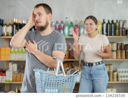 Man and woman quarrel in supermarket - they shout at each other Man and woman quarrel in supermarket - they shout at each other 134216330