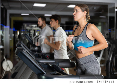 Woman running on a treadmill Woman running on a treadmill 134216443