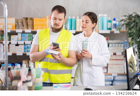 builder scans an ointment pack in a pharmacy builder scans an ointment pack in a pharmacy 134216624