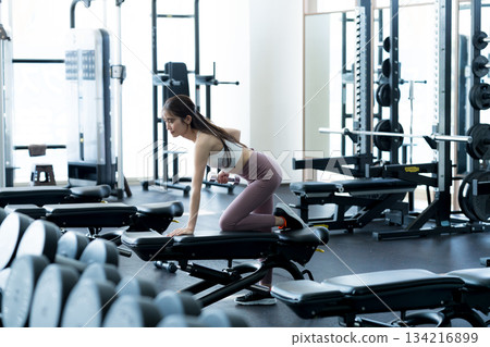 Young woman training in a sports gym Young woman training in a sports gym 134216899