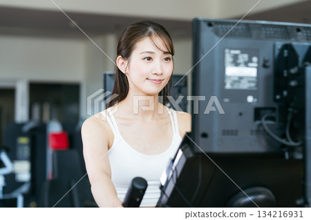 Young woman training in a sports gym Young woman training in a sports gym 134216931