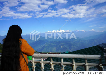 Rear view of woman overlooking snow-capped Kanchenjunga 134217388