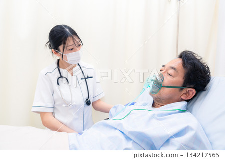 A female nurse caring for a patient on a ventilator 134217565