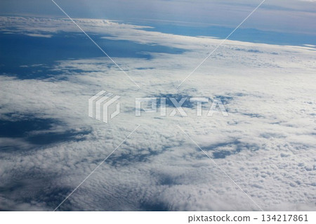 clouds and sky as seen through window of an airplane clouds and sky as seen through window of an airplane 134217861