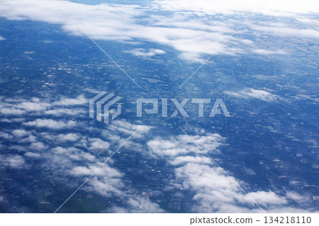 clouds and sky as seen through window of an airplane 134218110