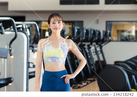 Young woman training in a sports gym Young woman training in a sports gym 134218242