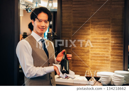 A male sommelier recommending wine 134218662