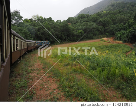 Misty mountains and curving trains - through the greenery of the Kuranda Tablelands Misty mountains and curving trains - through the greenery of the Kuranda Tablelands 134218955