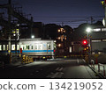 An early morning train passing through a railroad crossing 134219052