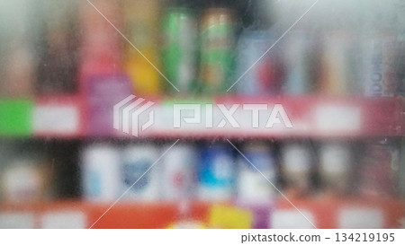 Blurry photo of bottled drinks on supermarket shelves 134219195